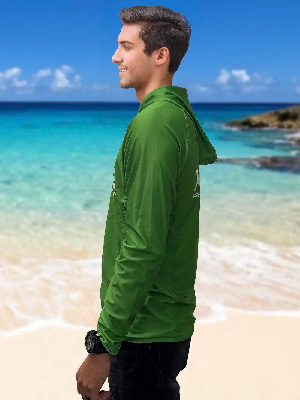 Man wearing XPECE green performance fishing hoodie sun shirt, side profile on beach background